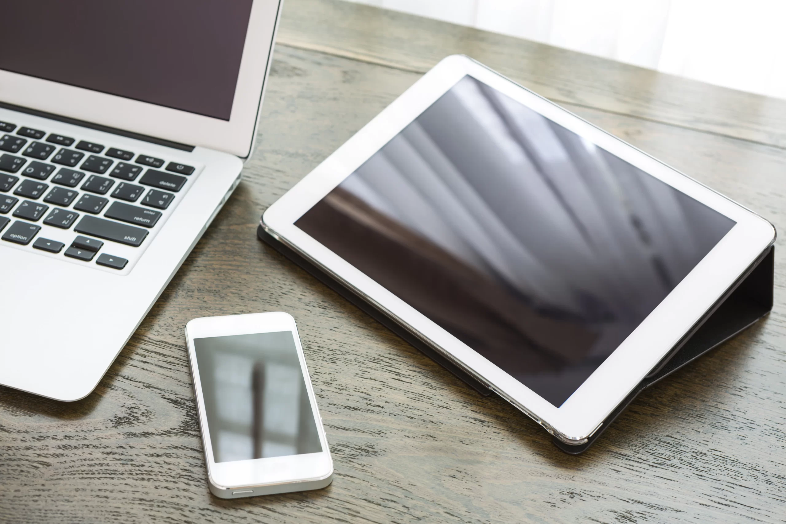 close-up-technological-devices-wooden-desk